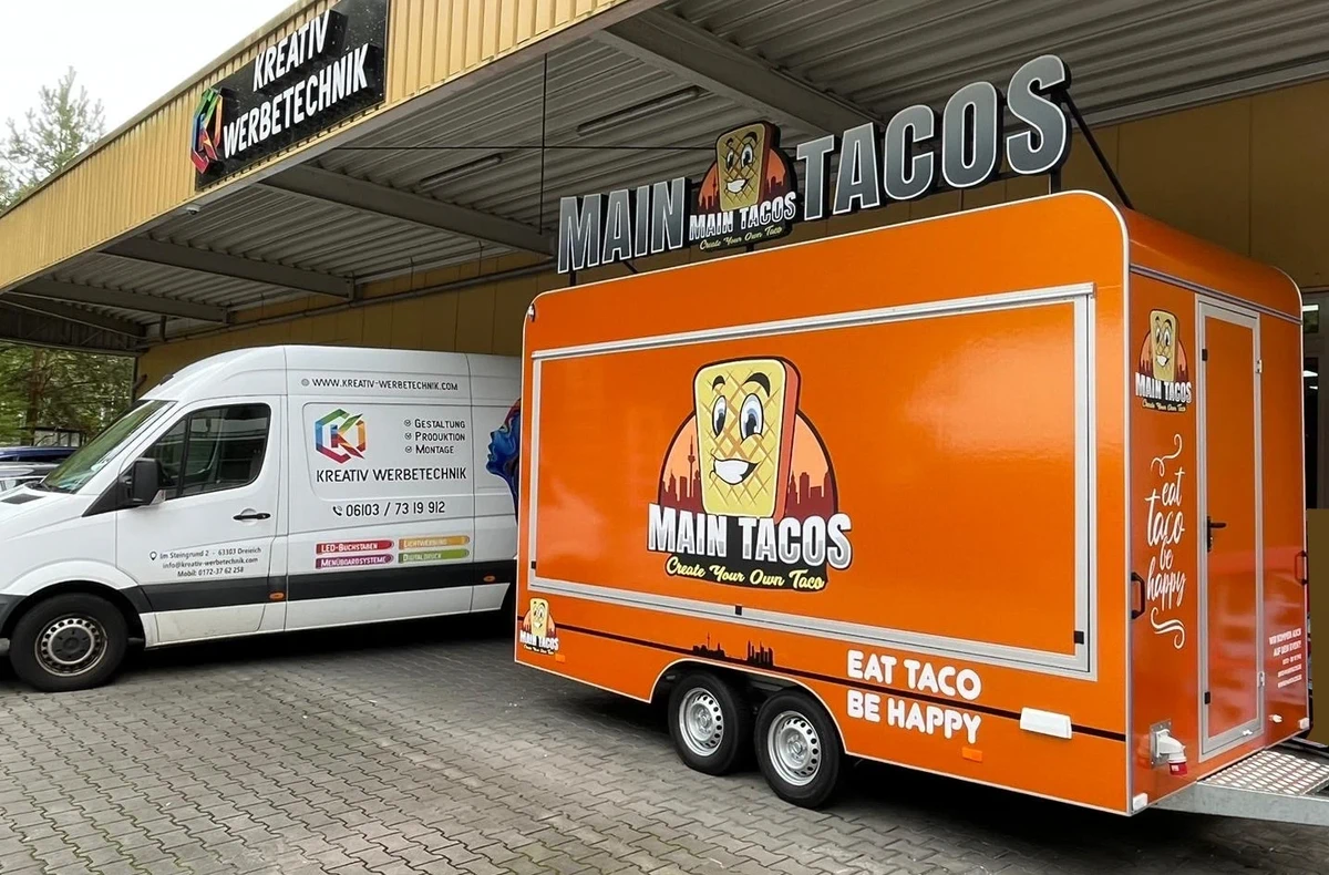 Transporter und Anhänger mit Beschriftung